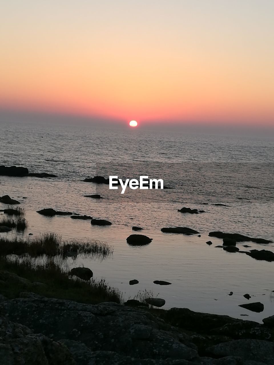 SCENIC VIEW OF SEA DURING SUNSET