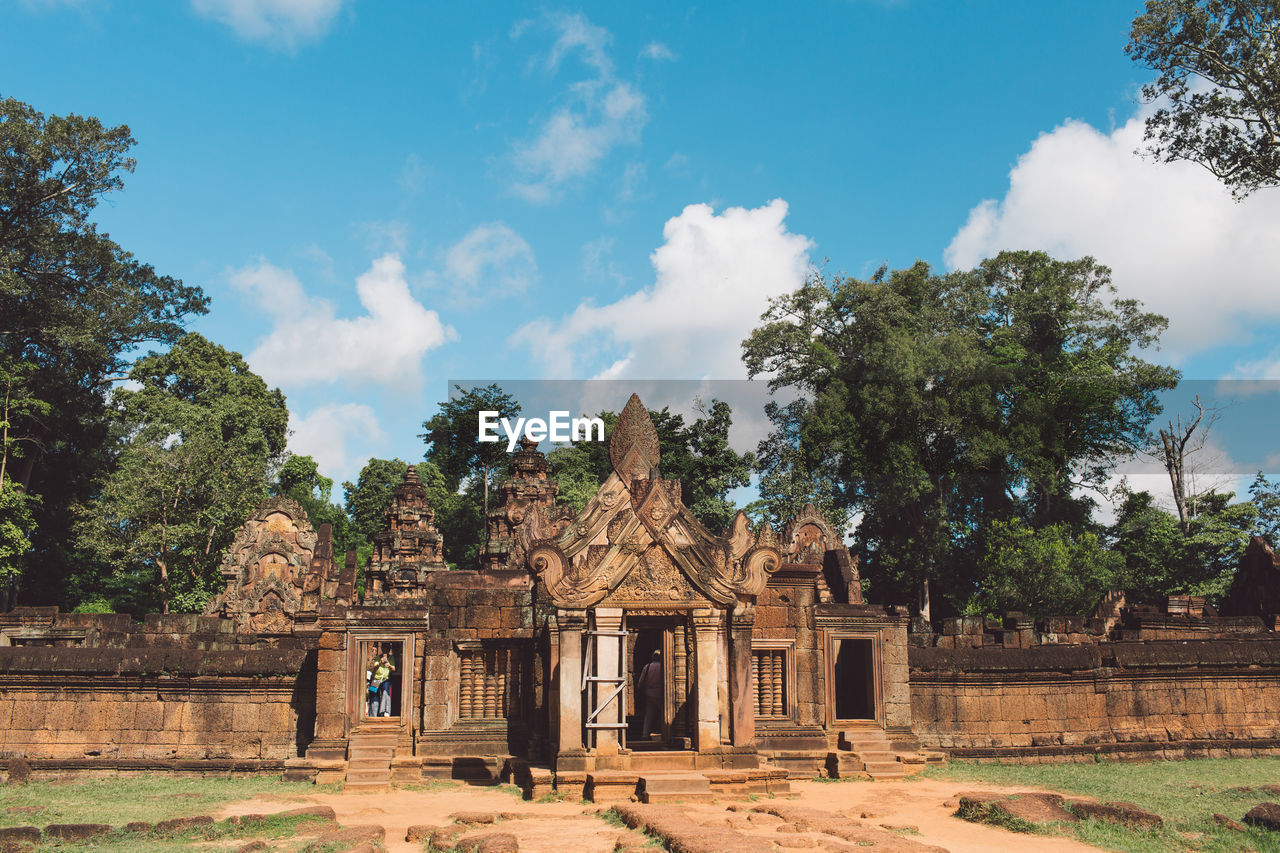 View of temple against cloudy sky during sunny day