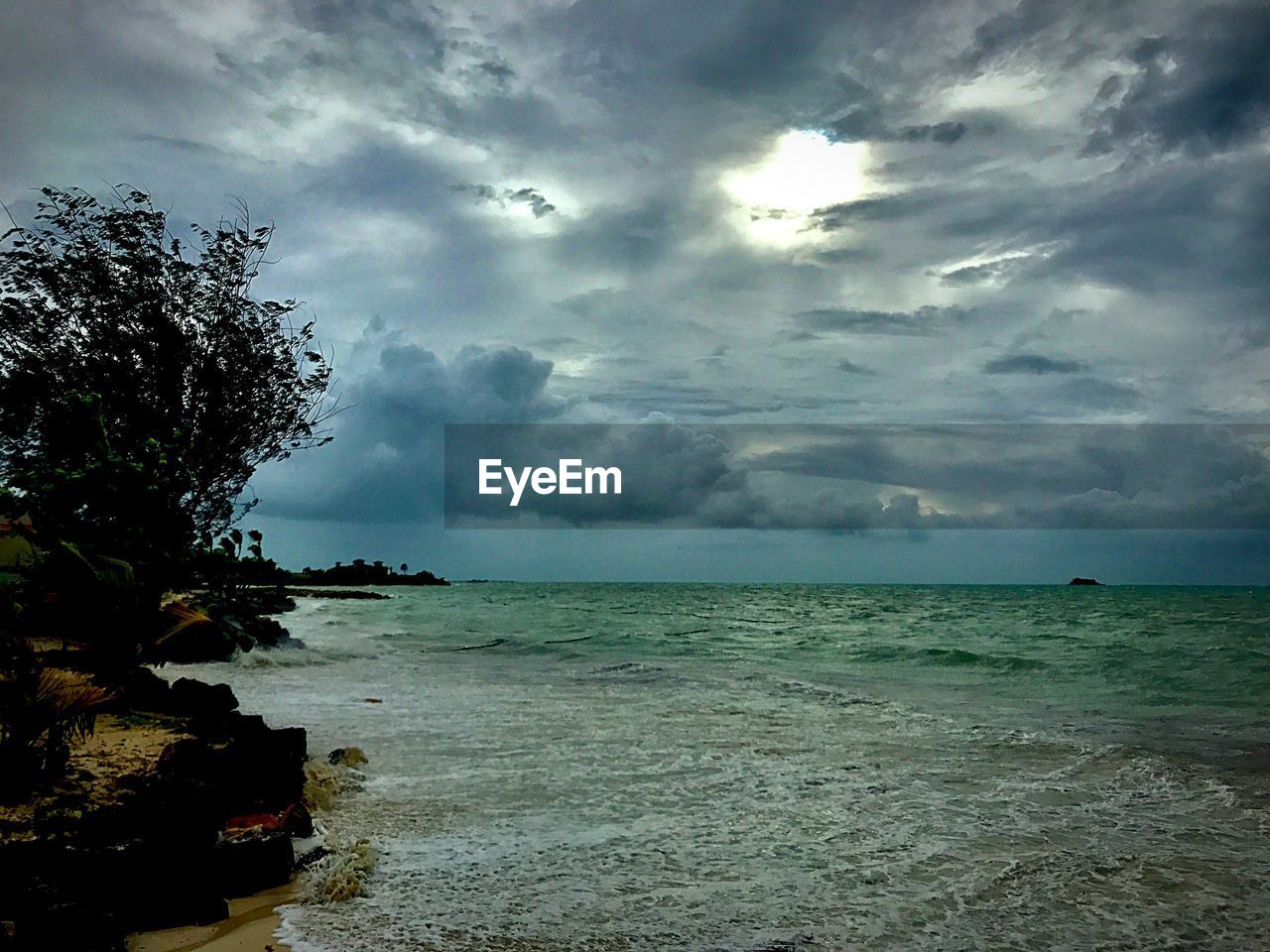 SCENIC VIEW OF SEA AGAINST STORM CLOUD SKY