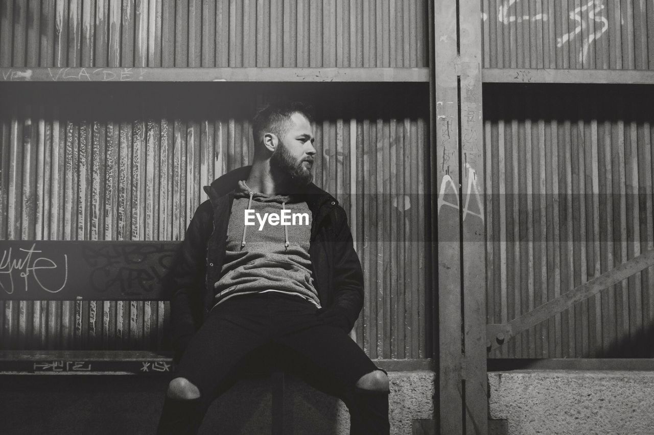 Young man sitting on park bench