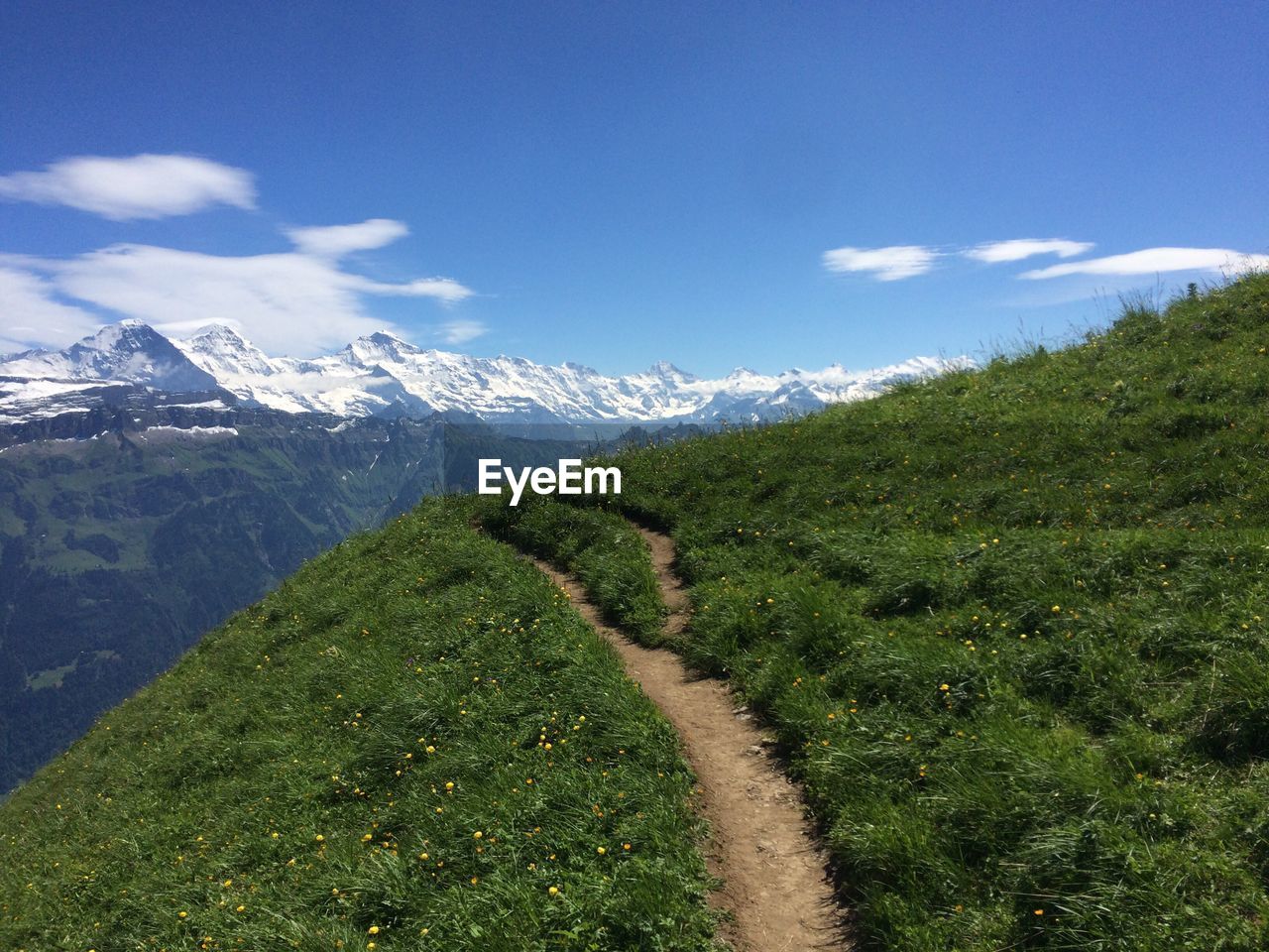 Scenic view of mountains against cloudy sky