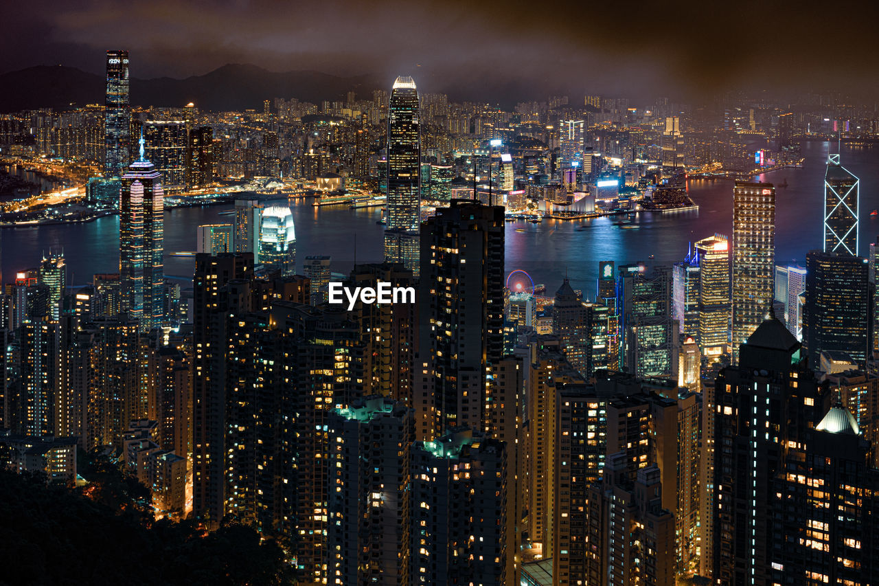 High angle view of illuminated buildings against sky at night