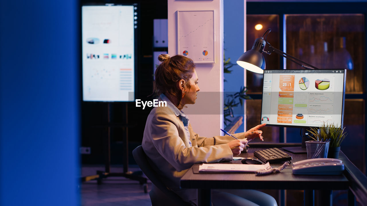 businesswoman using laptop on table in office