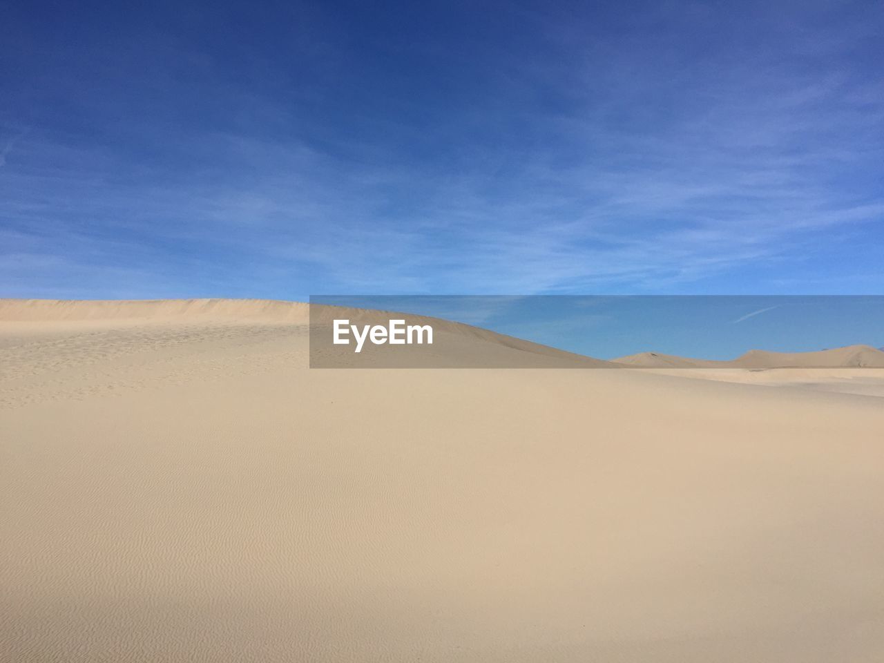 Scenic view of mesquite flat dunes against sky