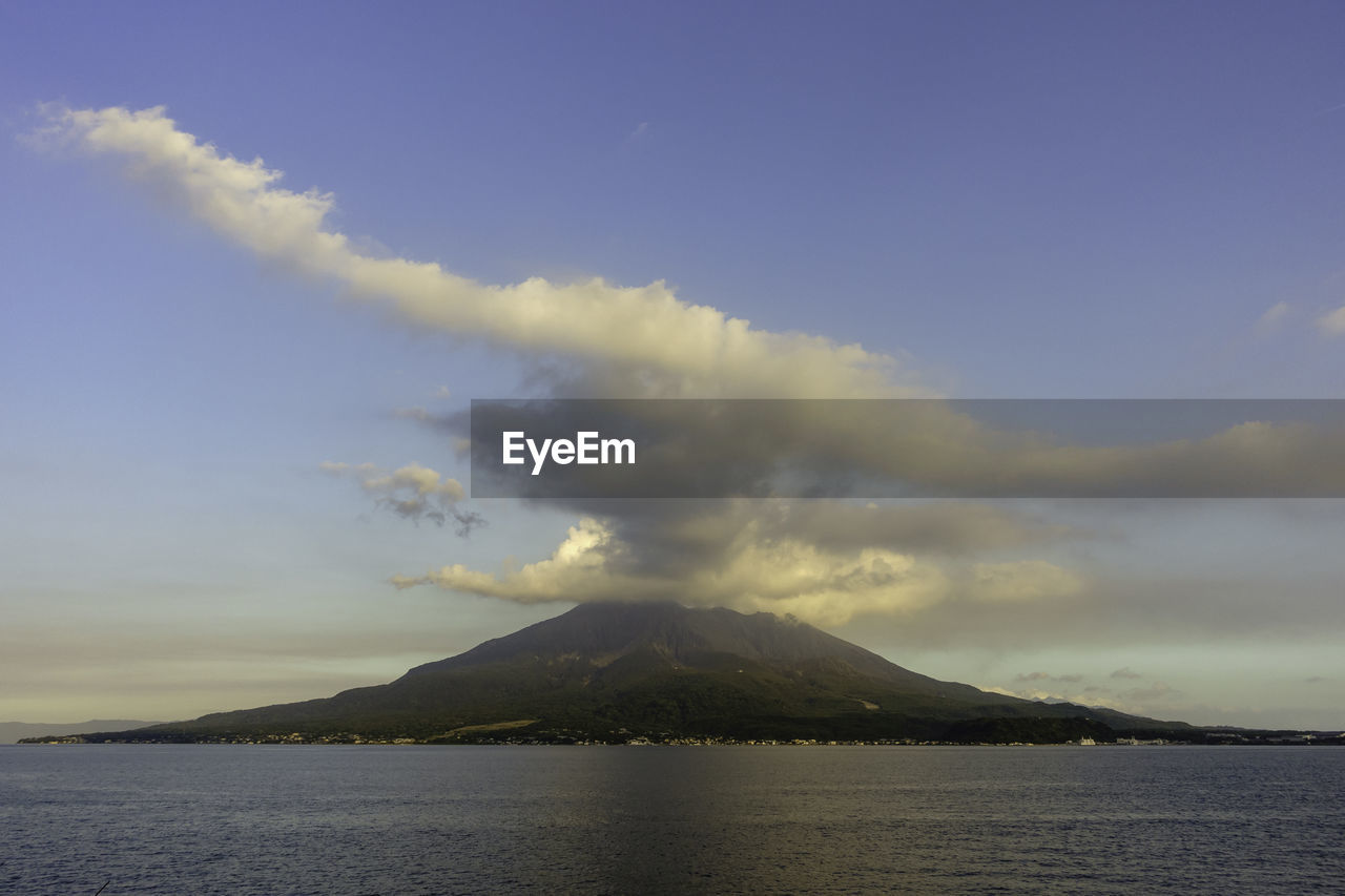 mountain, sky, volcano, horizon, cloud, beauty in nature, water, scenics - nature, sea, nature, environment, dawn, land, landscape, no people, smoke, travel destinations, geology, volcanic landscape, non-urban scene, ocean, erupting, active volcano, outdoors, tranquility, tranquil scene, coast, morning, travel, stratovolcano, sunrise, sunlight, day, power in nature