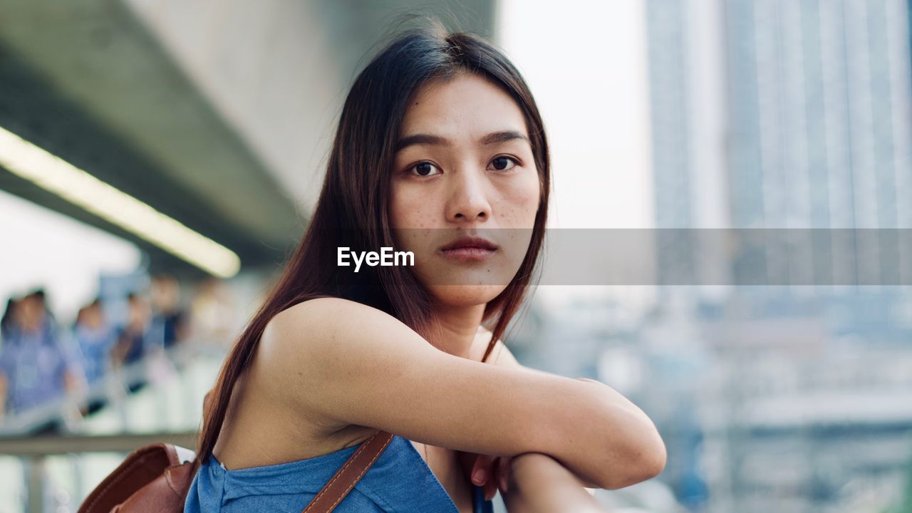 Close-up portrait of young woman in city