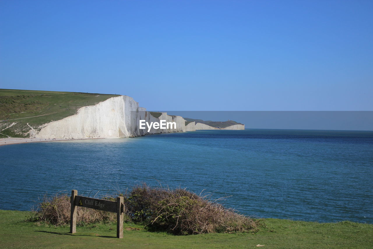 Scenic view of sea against clear blue sky