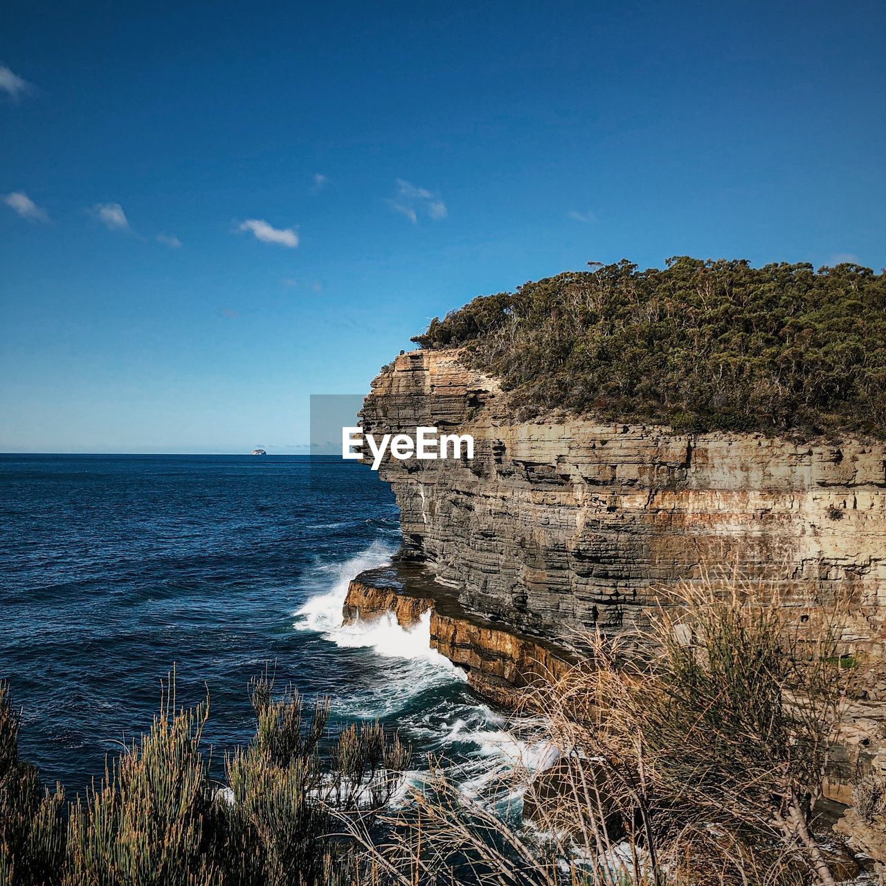 Scenic view of sea against blue sky