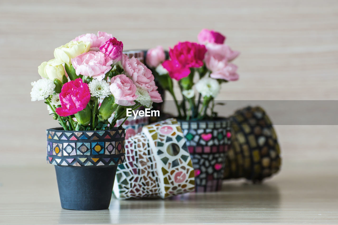 CLOSE-UP OF PINK ROSES ON TABLE