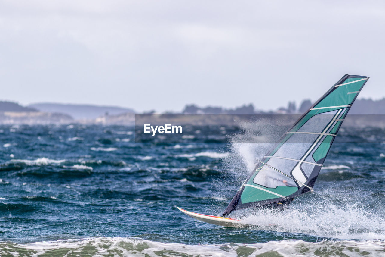 VIEW OF SAILBOAT IN SEA AGAINST SKY