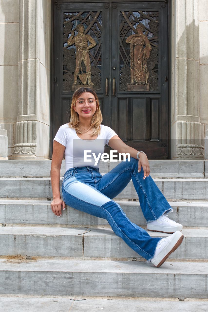 Portrait of woman sitting on steps