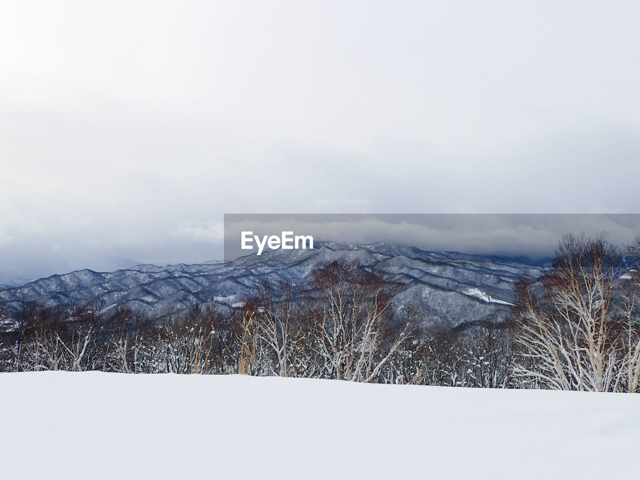 SNOW COVERED MOUNTAINS AGAINST SKY