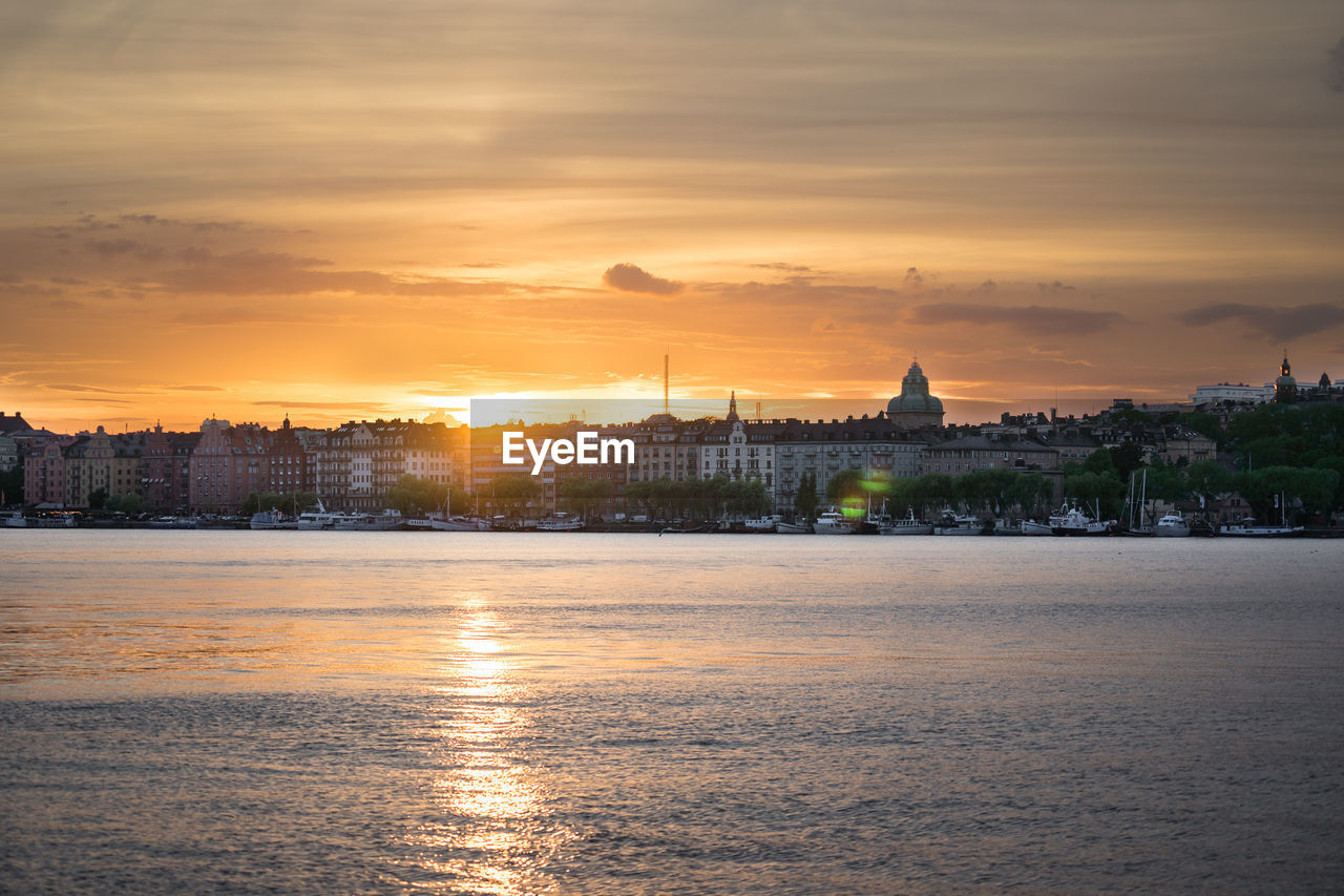 Scenic view of buildings against sky during sunset