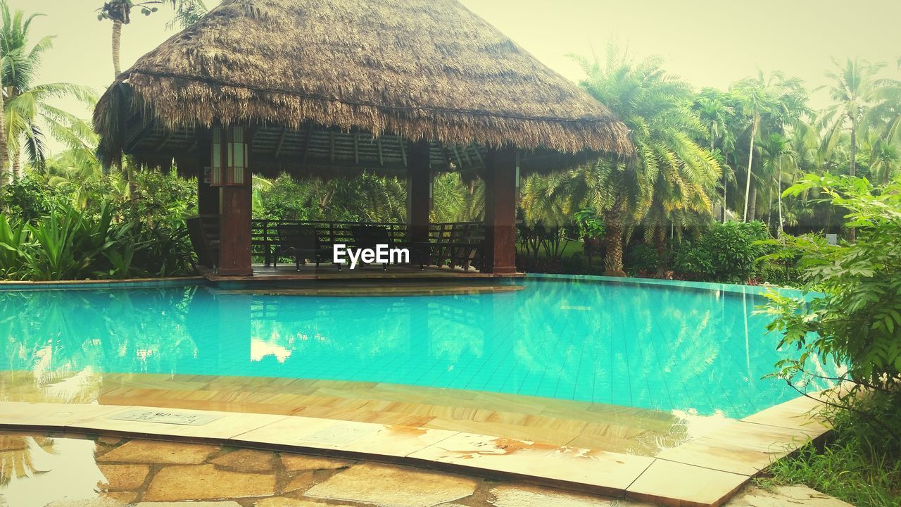 Thatched roof house on poolside