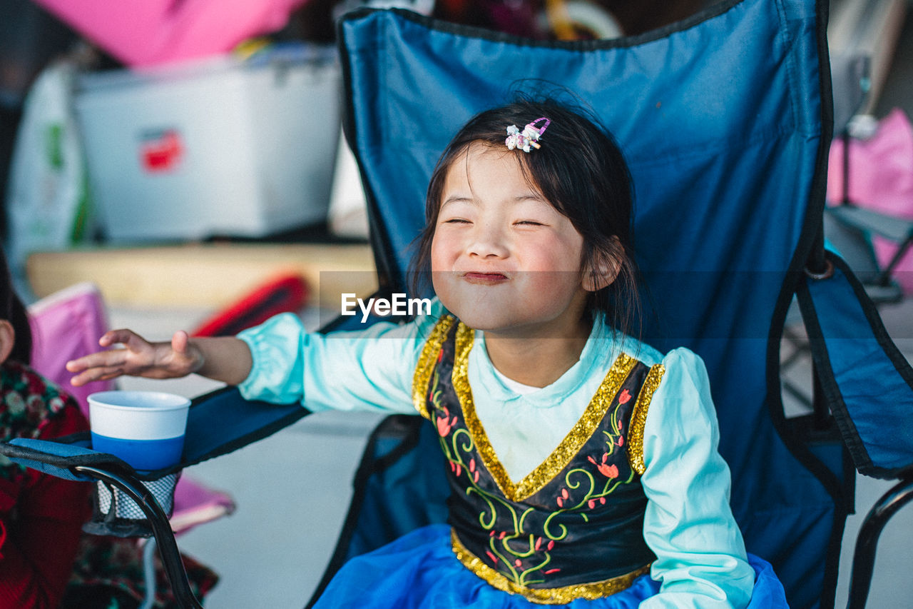 Girl puckering while sitting on chair