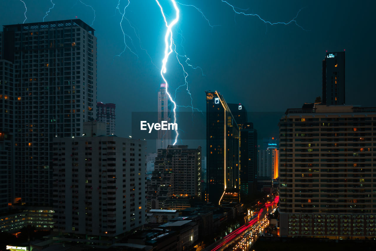 Aerial view of illuminated city against sky at night