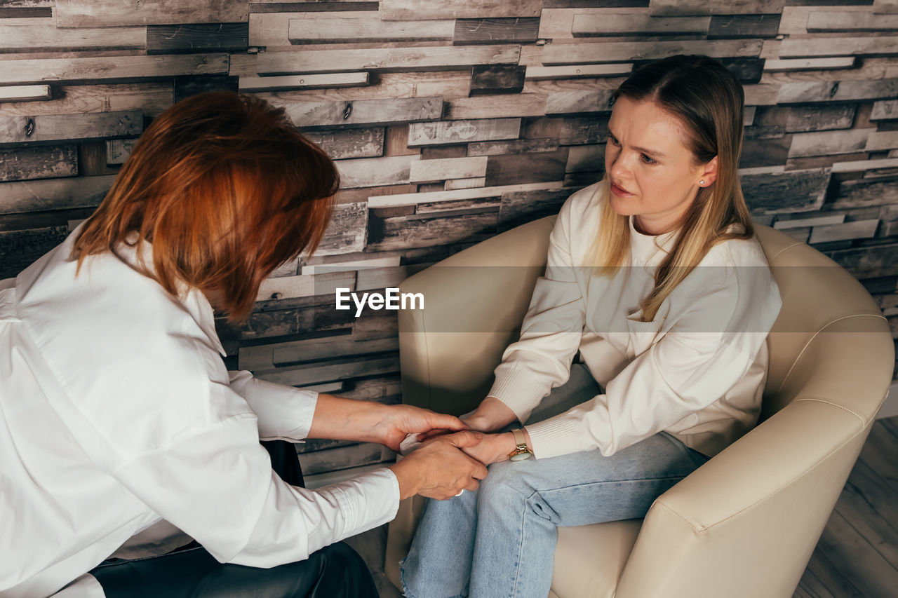 Depressed woman talking to psychotherapist at office.