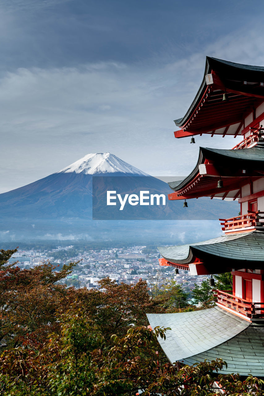 Temple in city against mountains