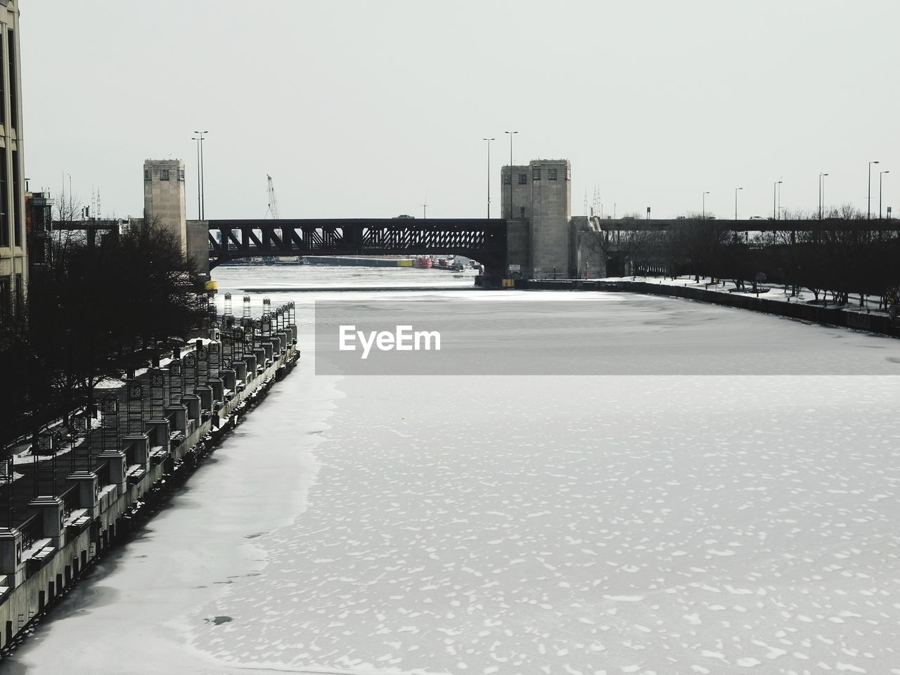 BRIDGE IN CITY AGAINST CLEAR SKY DURING WINTER