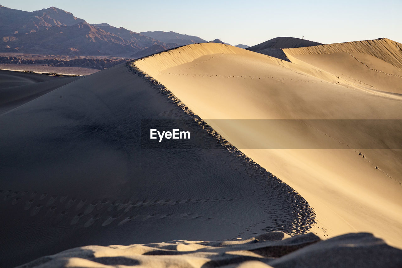 Dunes at sunrise with person