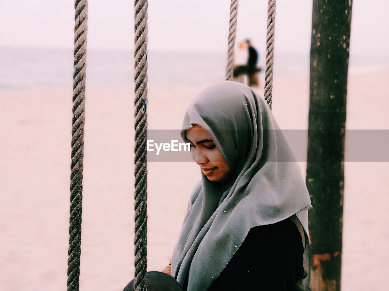 Woman wearing hijab at beach