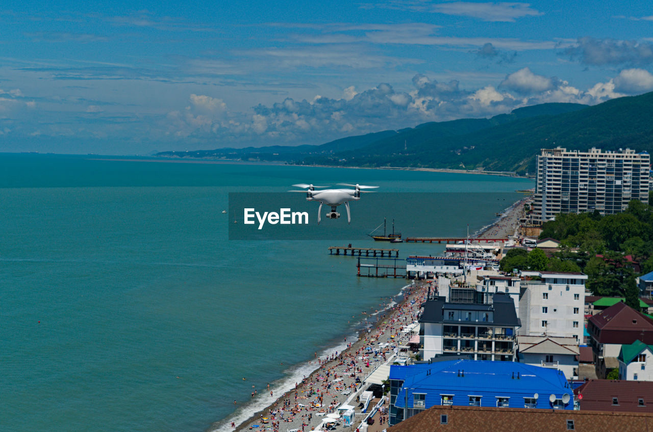 water, sea, architecture, coast, transportation, nautical vessel, nature, land, ocean, beach, sky, building exterior, travel, travel destinations, built structure, city, bay, mode of transportation, vacation, harbor, building, scenics - nature, tourism, coastline, ship, blue, mountain, high angle view, body of water, vehicle, no people, environment, outdoors, landscape, beauty in nature, day, horizon, pier, holiday, trip, aerial view, industry, aerial photography, cloud, bay of water, port, cityscape, sunlight, shore, residential district, island