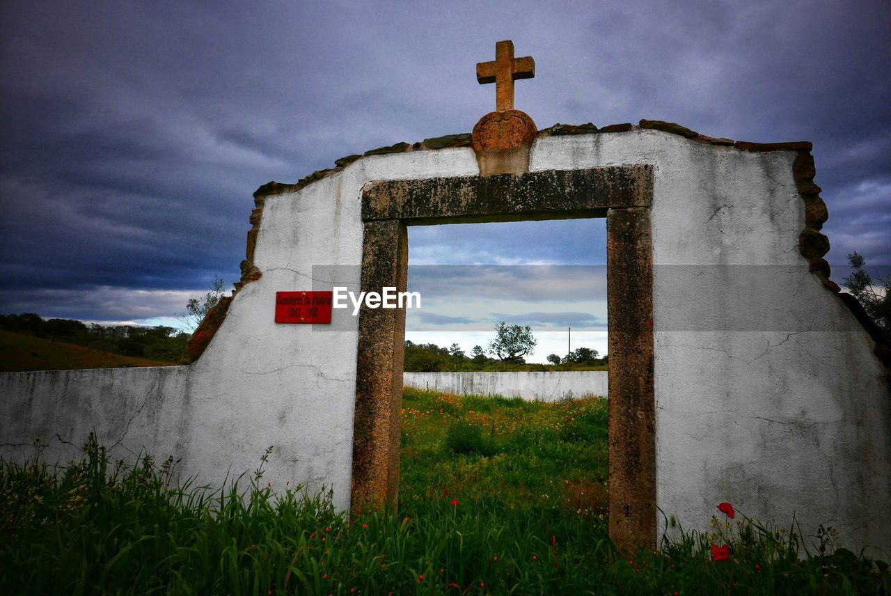 Historic building on field against sky