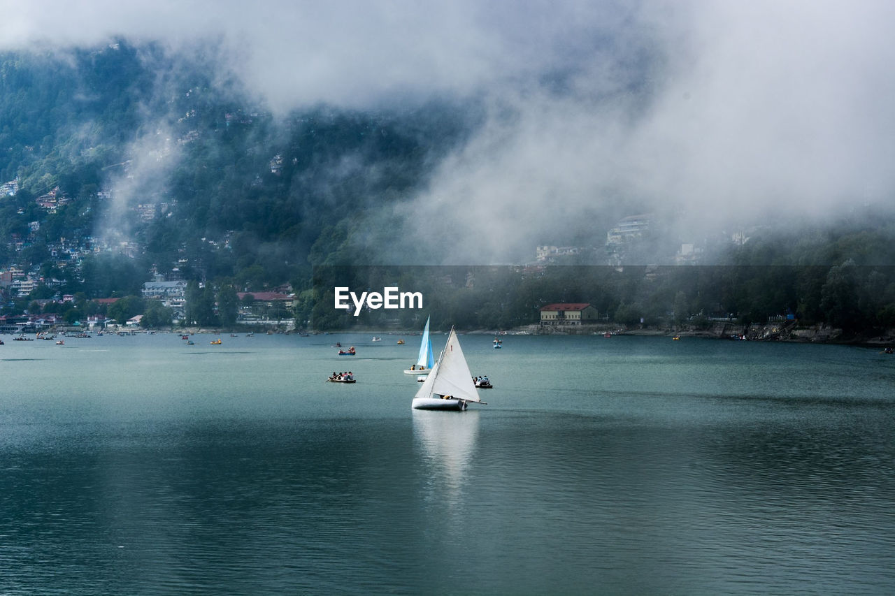 Sailboat in sea against sky