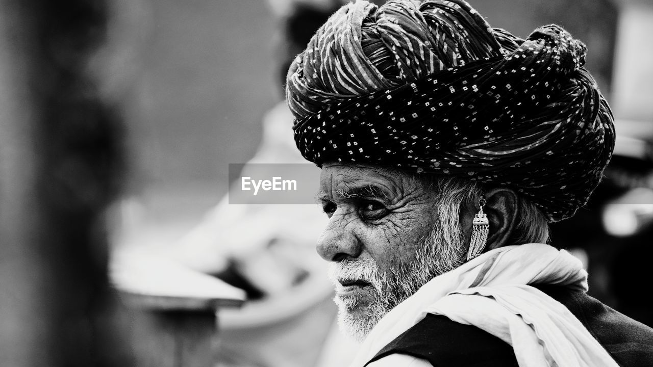 Close-up of man wearing turban looking away