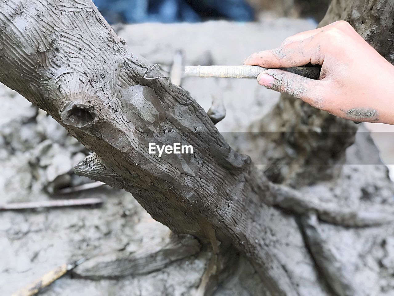 Cropped hand sculpting on wet clay