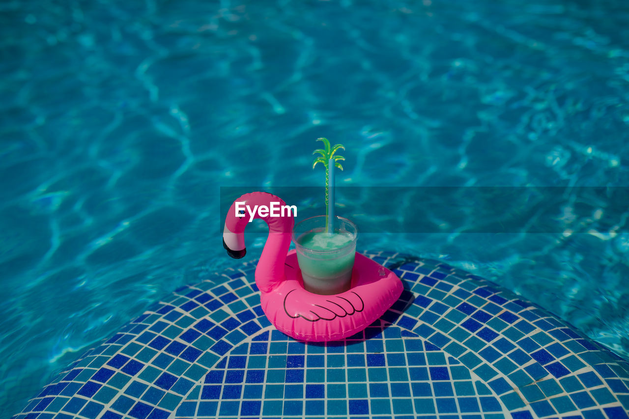 High angle view of toy floating on swimming pool