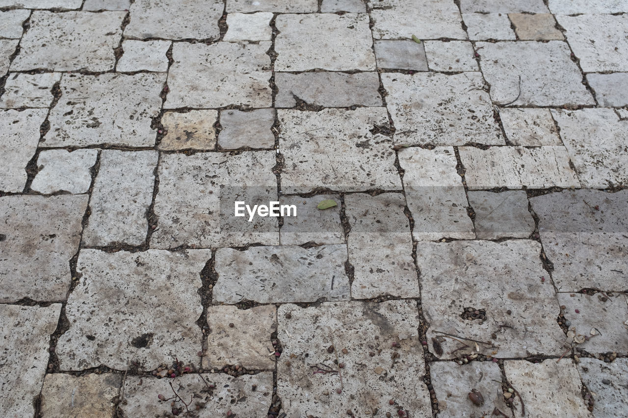 HIGH ANGLE VIEW OF STONE COBBLESTONE STREET