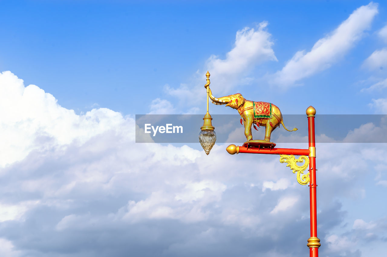 cloud, sky, nature, blue, no people, sign, outdoors, communication, day, guidance, representation, architecture, low angle view, cloudscape, copy space, travel, animal representation