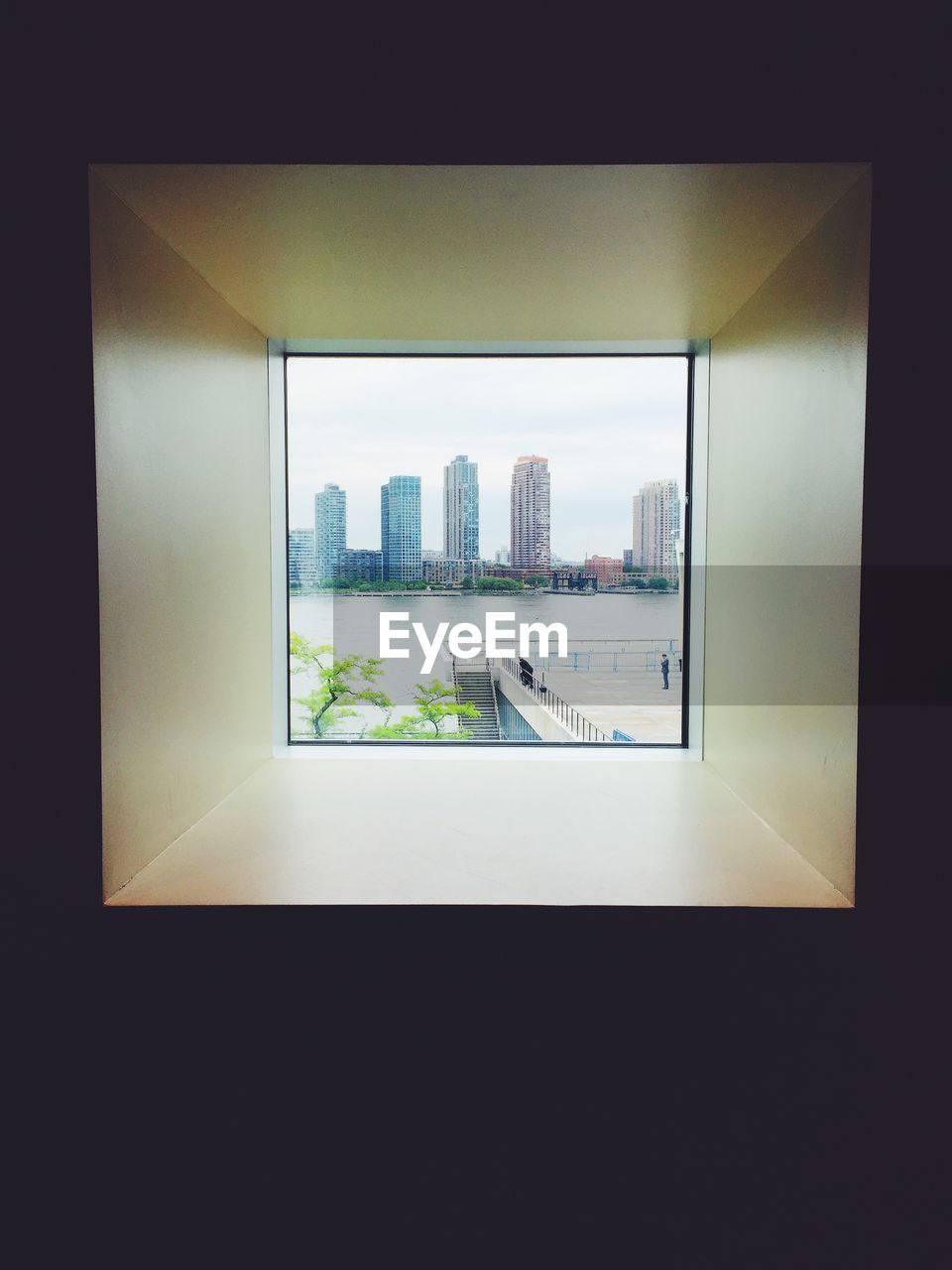 Waterfront buildings seeing through square window