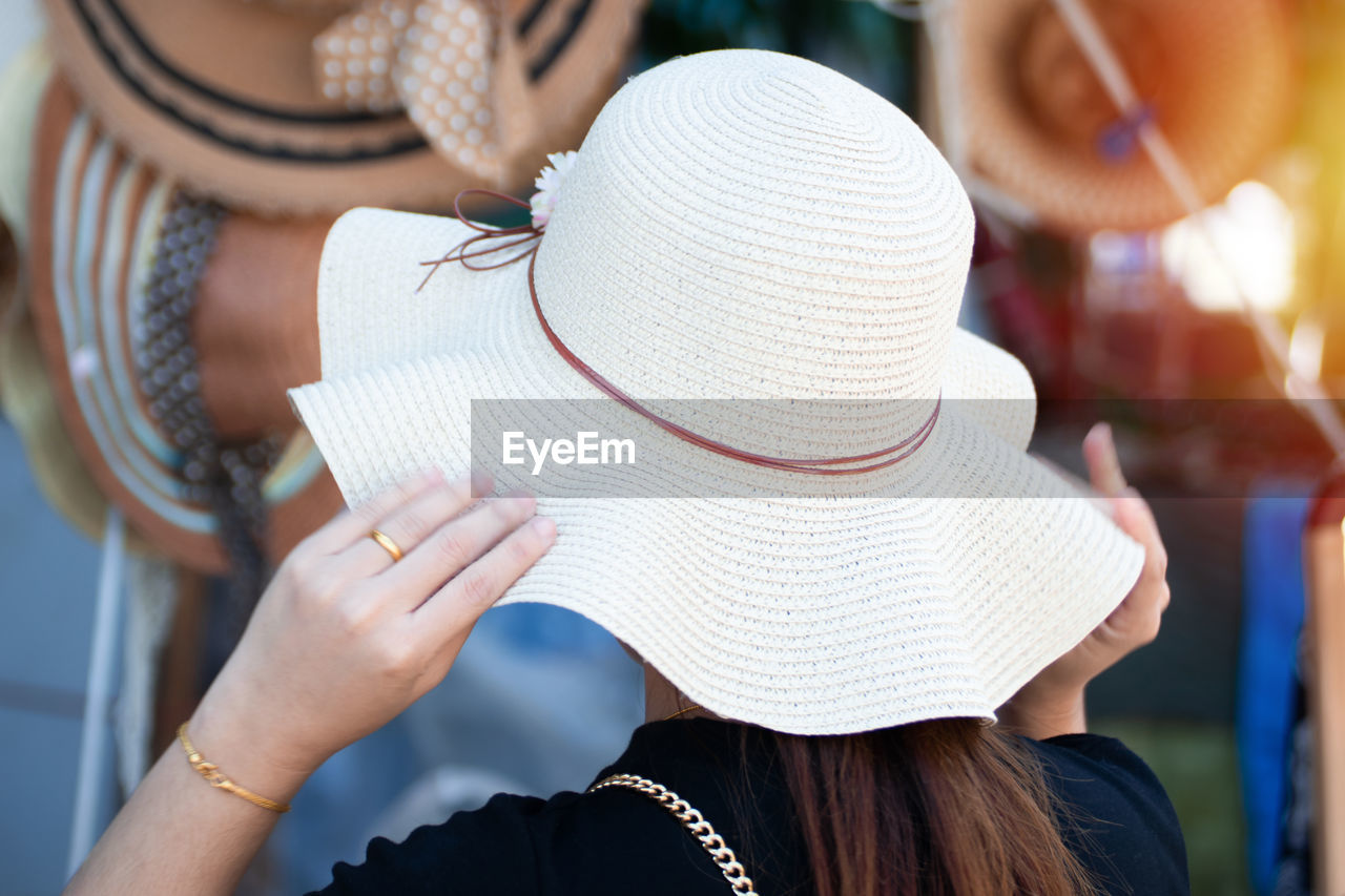 Rear view of woman wearing hat at market place