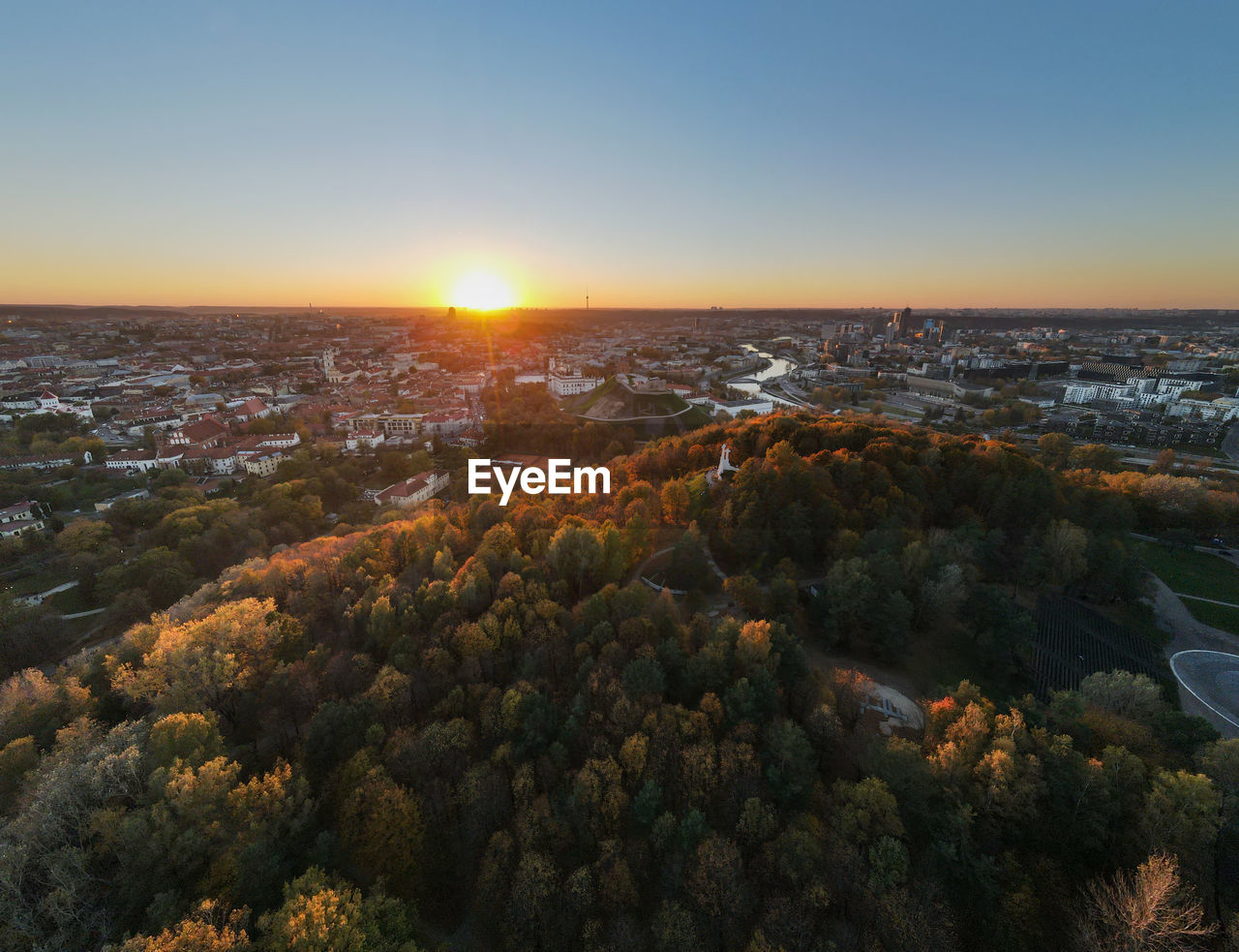 HIGH ANGLE VIEW OF CITYSCAPE DURING SUNSET