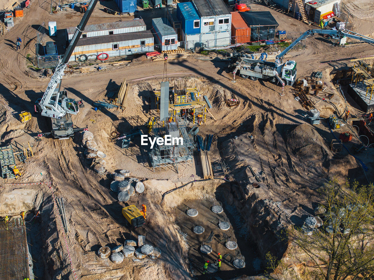 aerial photography, high angle view, transportation, day, industry, nature, construction industry, architecture, environment, outdoors, no people, mode of transportation, built structure, land, sunlight, construction site, aerial view, city, landscape, building exterior