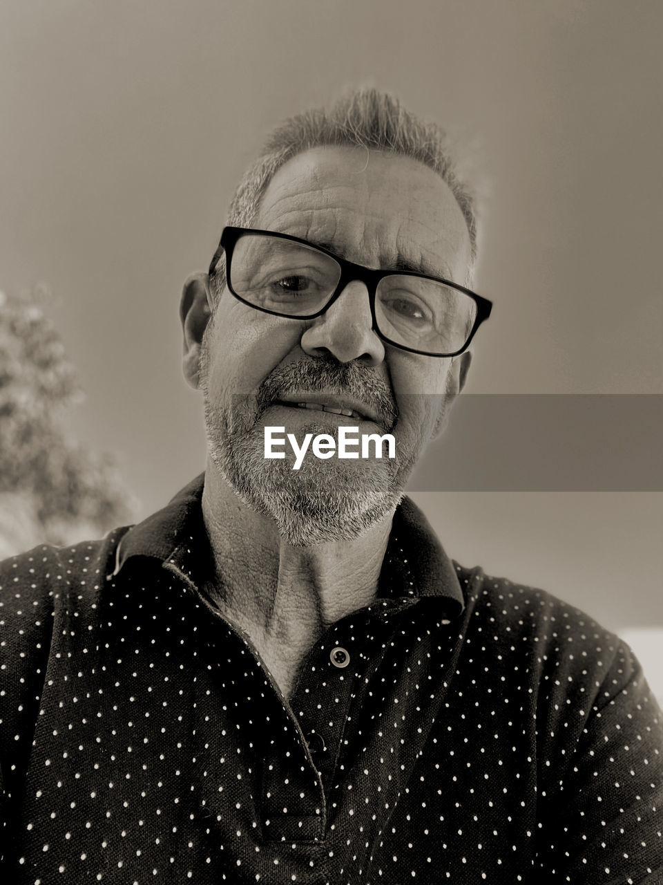 eyeglasses, glasses, portrait, adult, one person, headshot, black and white, facial hair, men, beard, monochrome, moustache, front view, person, mature adult, monochrome photography, senior adult, black, vision care, portrait photography, eyewear, looking at camera, white, casual clothing, indoors, lifestyles, emotion, smiling, human face, looking, human hair, close-up, gray hair, hairstyle, studio shot, seniors, contemplation, happiness