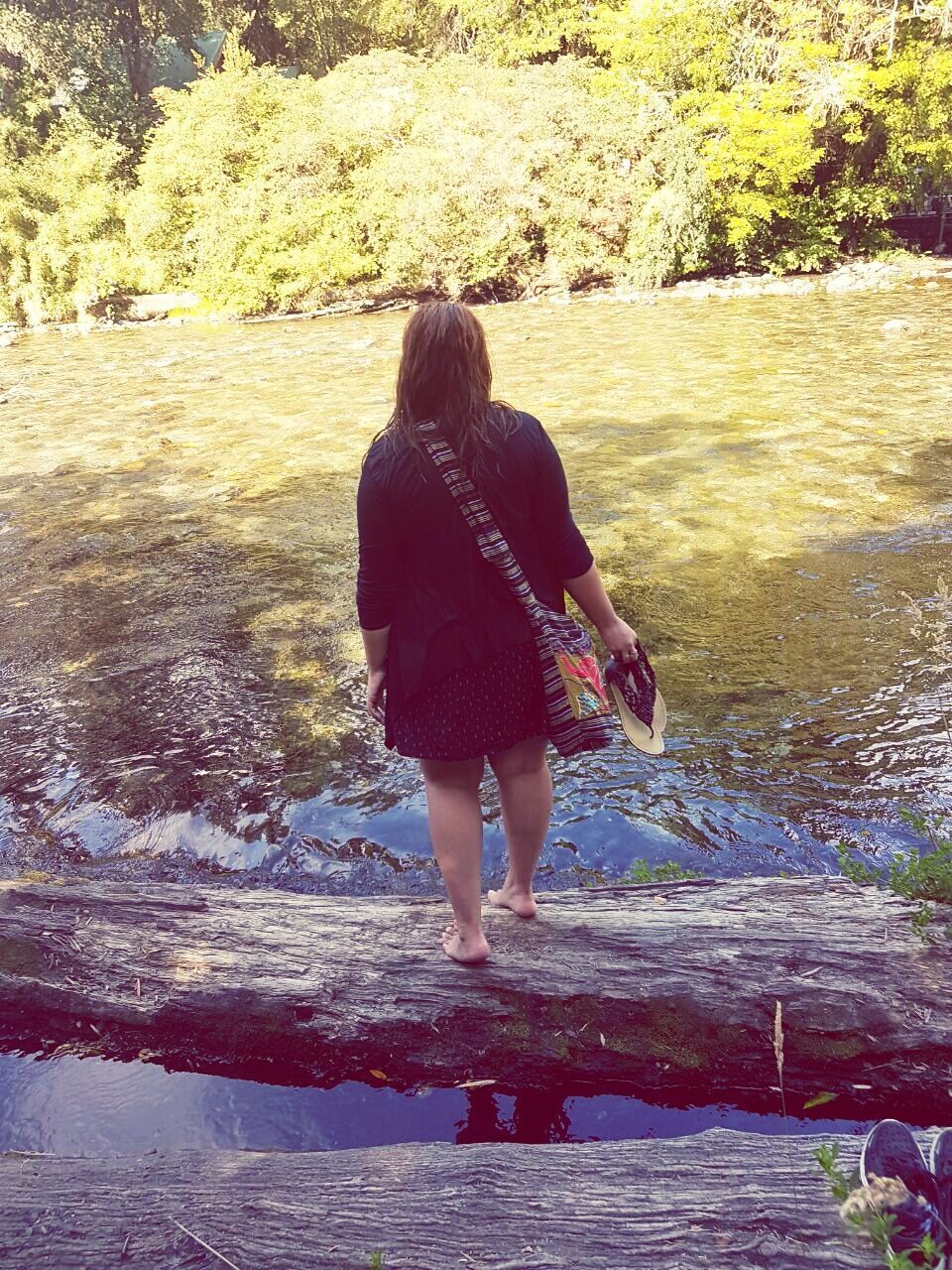 REAR VIEW OF BOY ON WATER AT PARK