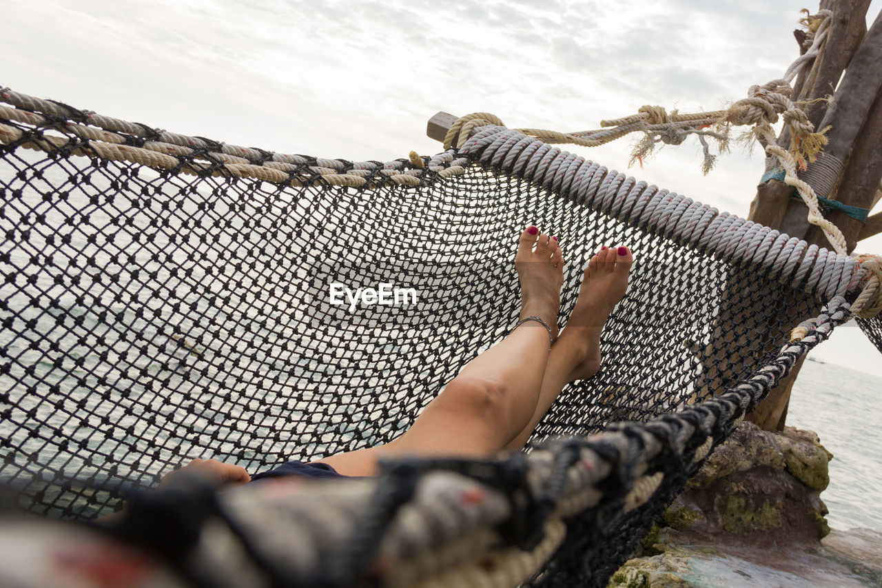 LOW SECTION OF WOMEN RELAXING ON ROPE