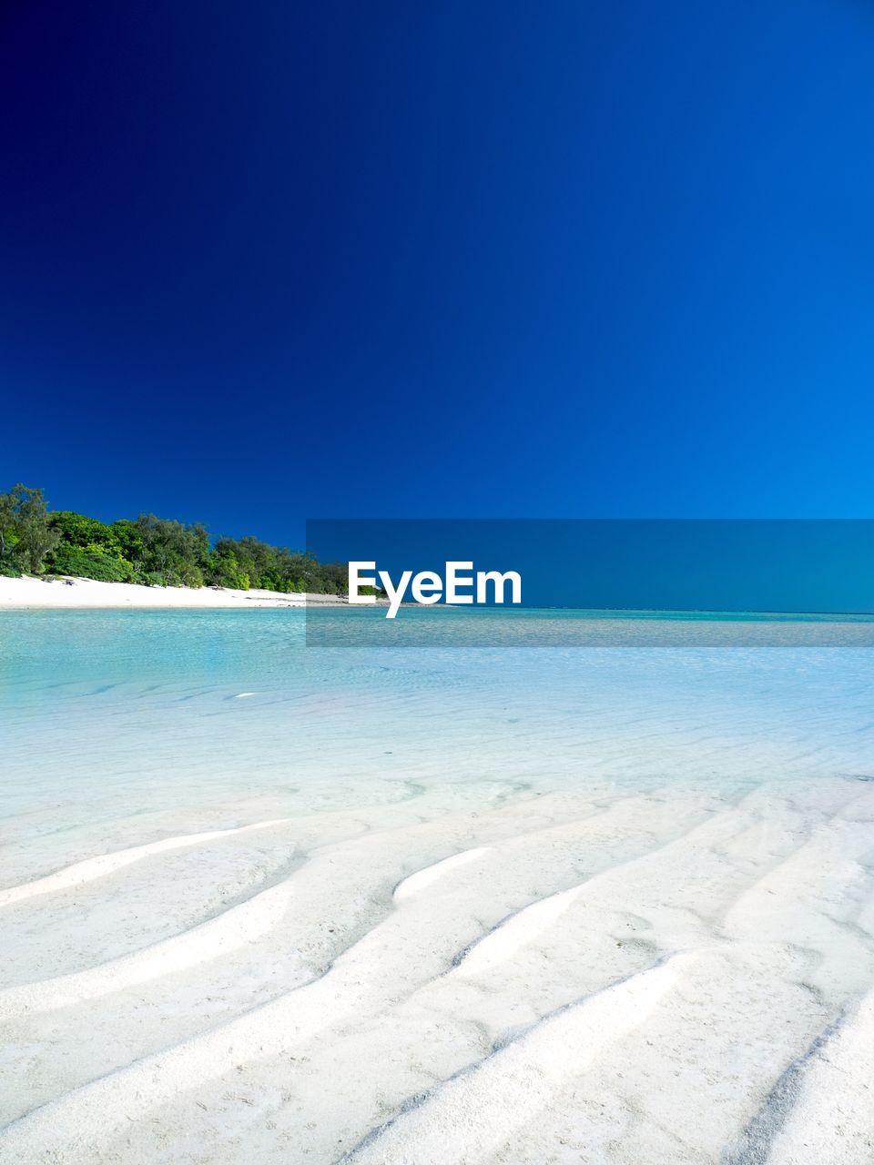 View of beach against blue sky