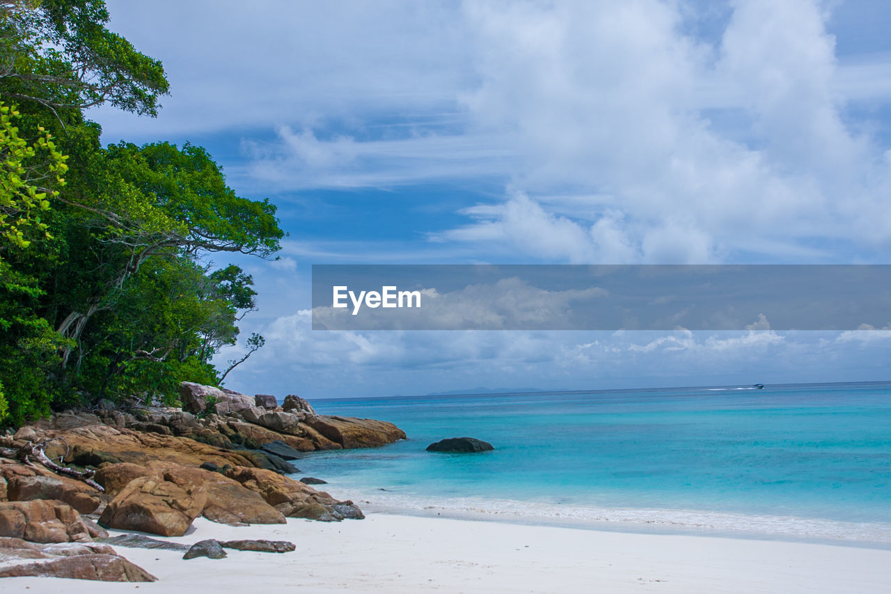 SCENIC VIEW OF BEACH AGAINST BLUE SKY