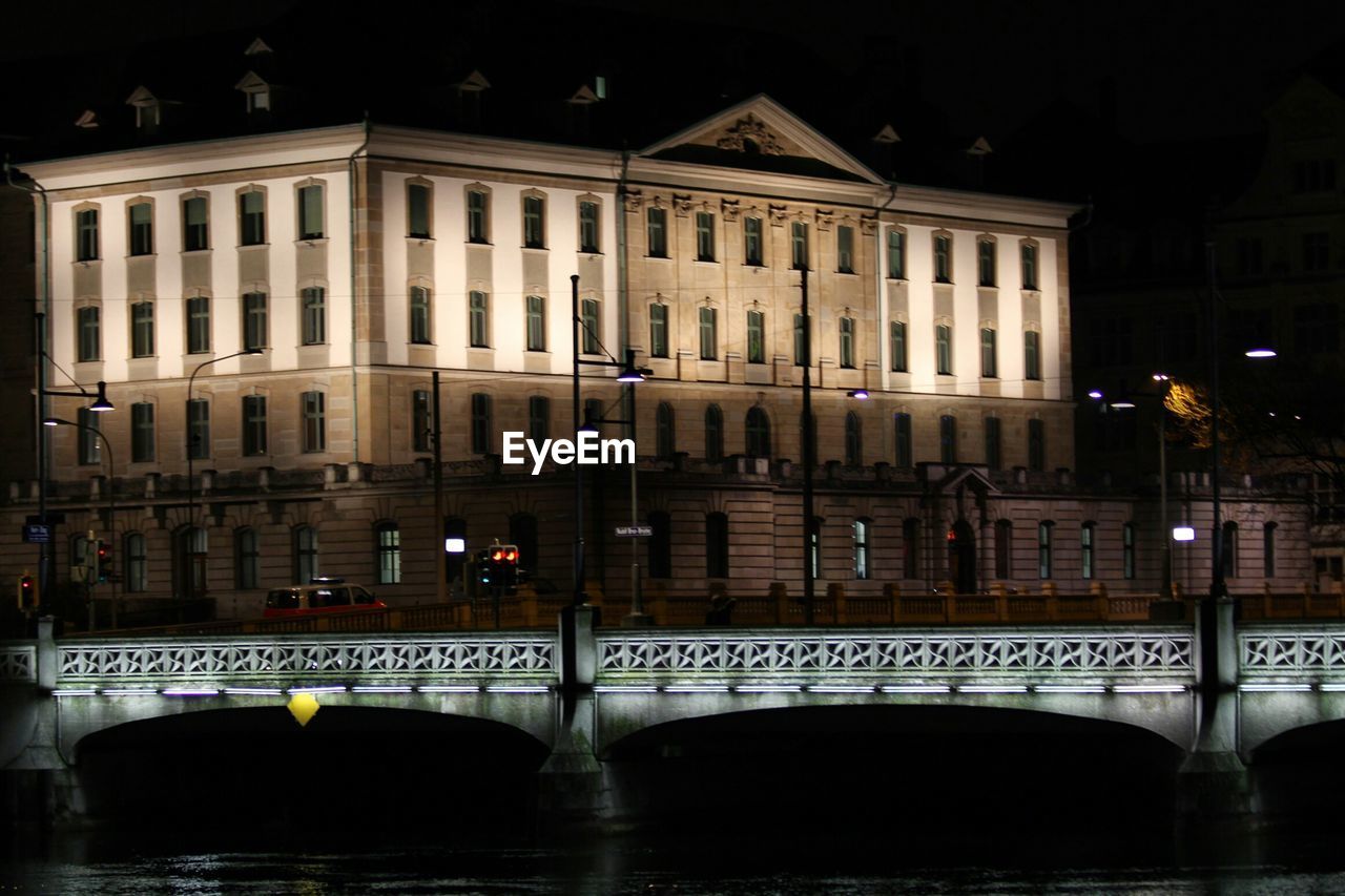 ILLUMINATED BRIDGE OVER RIVER