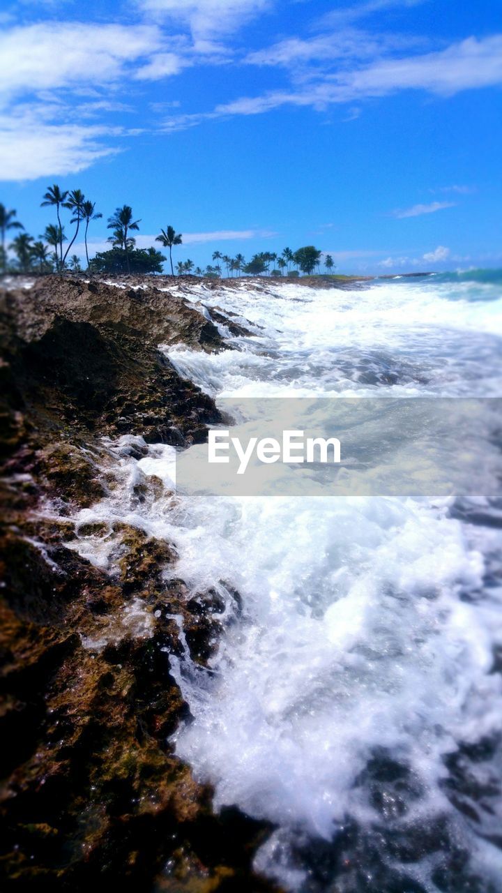 High angle view of waves on rocks at shore