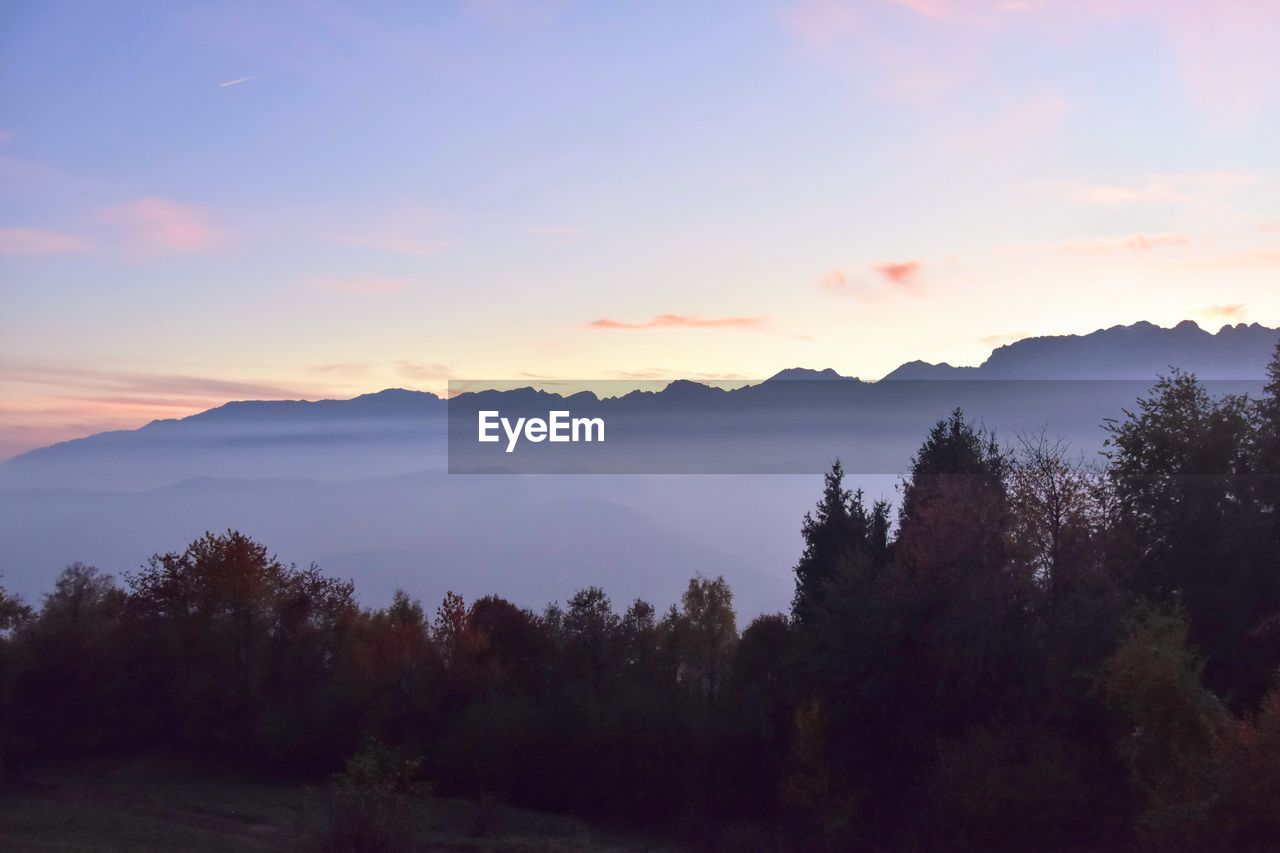 Scenic view of mountains against sky at sunset