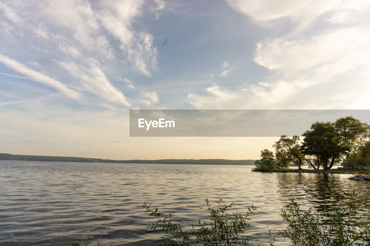 water, sky, cloud, sea, nature, beauty in nature, scenics - nature, shore, tranquility, tree, plant, tranquil scene, beach, land, body of water, environment, reflection, tropical climate, travel, horizon, sunset, travel destinations, sunlight, outdoors, no people, idyllic, landscape, vacation, trip, palm tree, holiday, seascape, coast, horizon over water, ocean, tourism, summer, bay, day, island, non-urban scene, dusk, nautical vessel, coastline, blue, relaxation