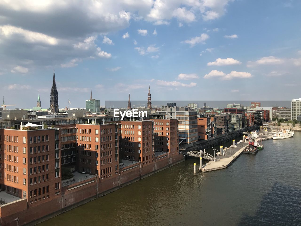 View of buildings in city against cloudy sky