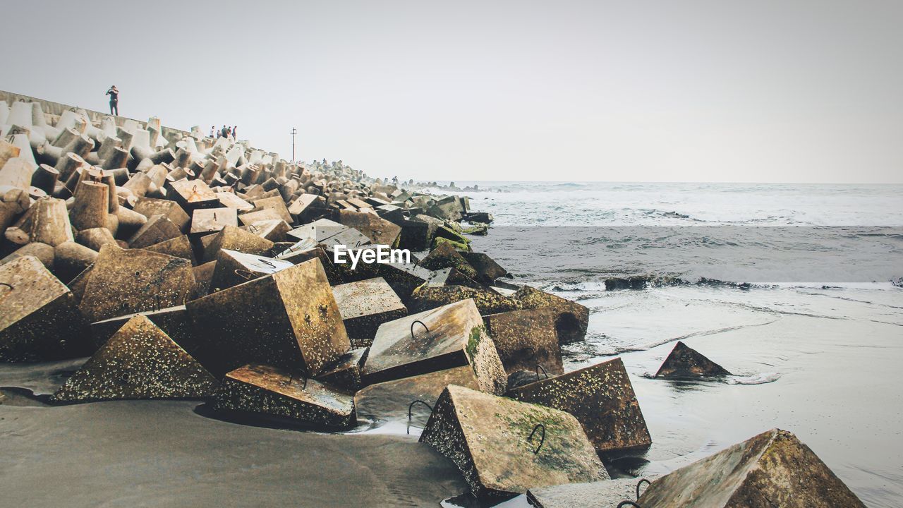 Low angle view of concrete block on coastline