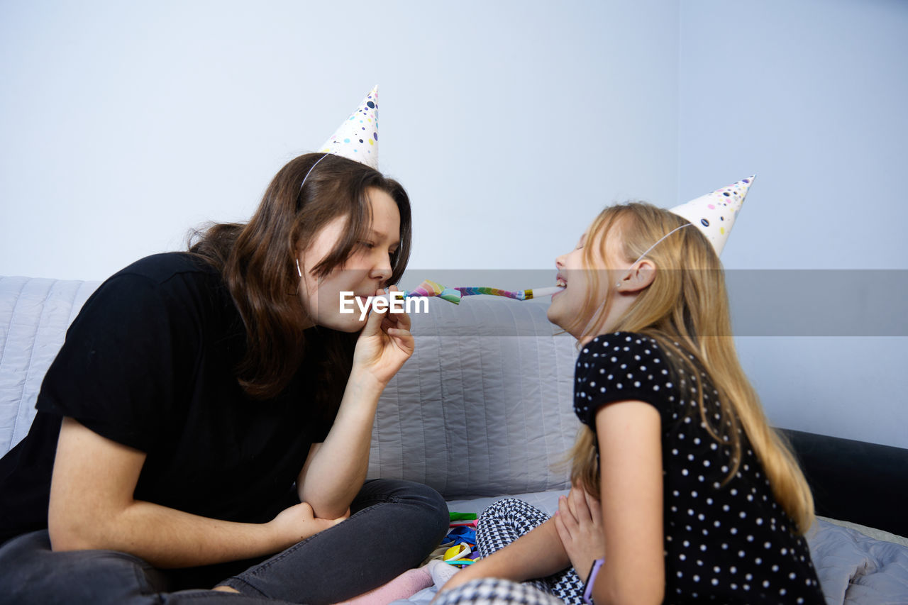 Children have fun playing, blowing up colorful balloons, at a birthday party