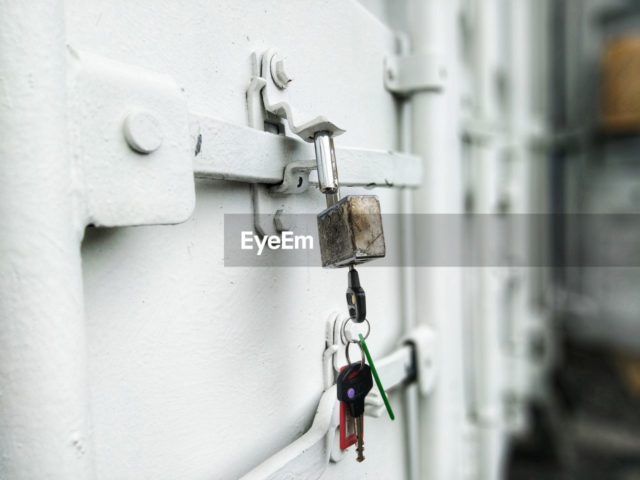 Close-up of metal chain against white wall